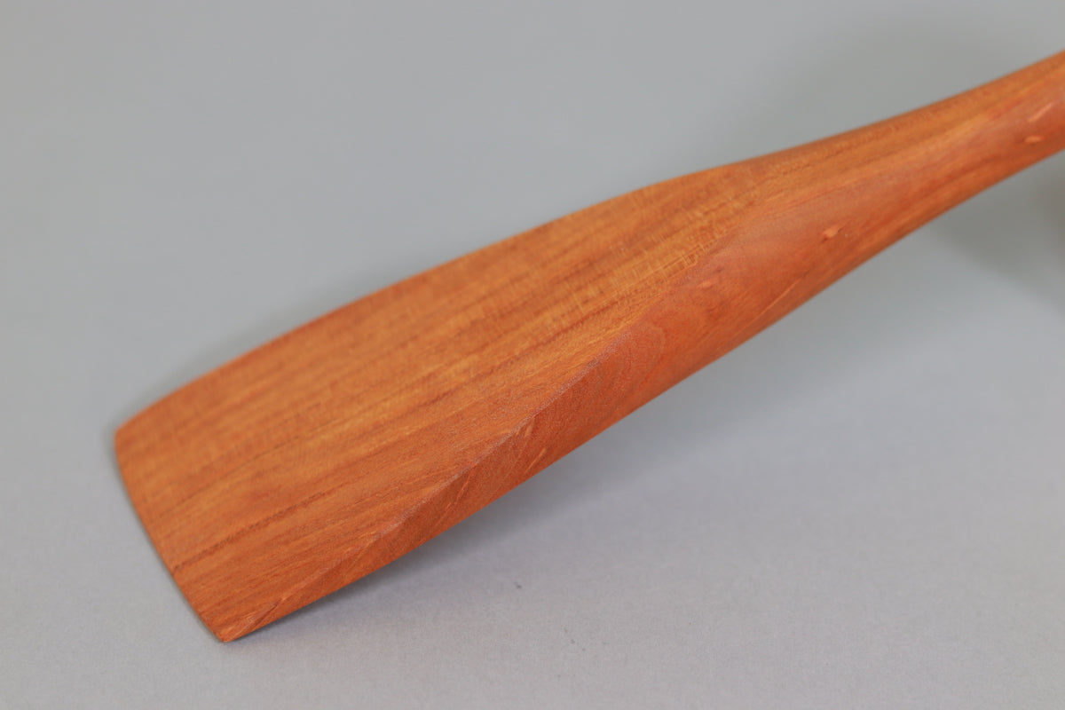 a view of the blade of a cherry sauté stirrer made of urban salvaged wood