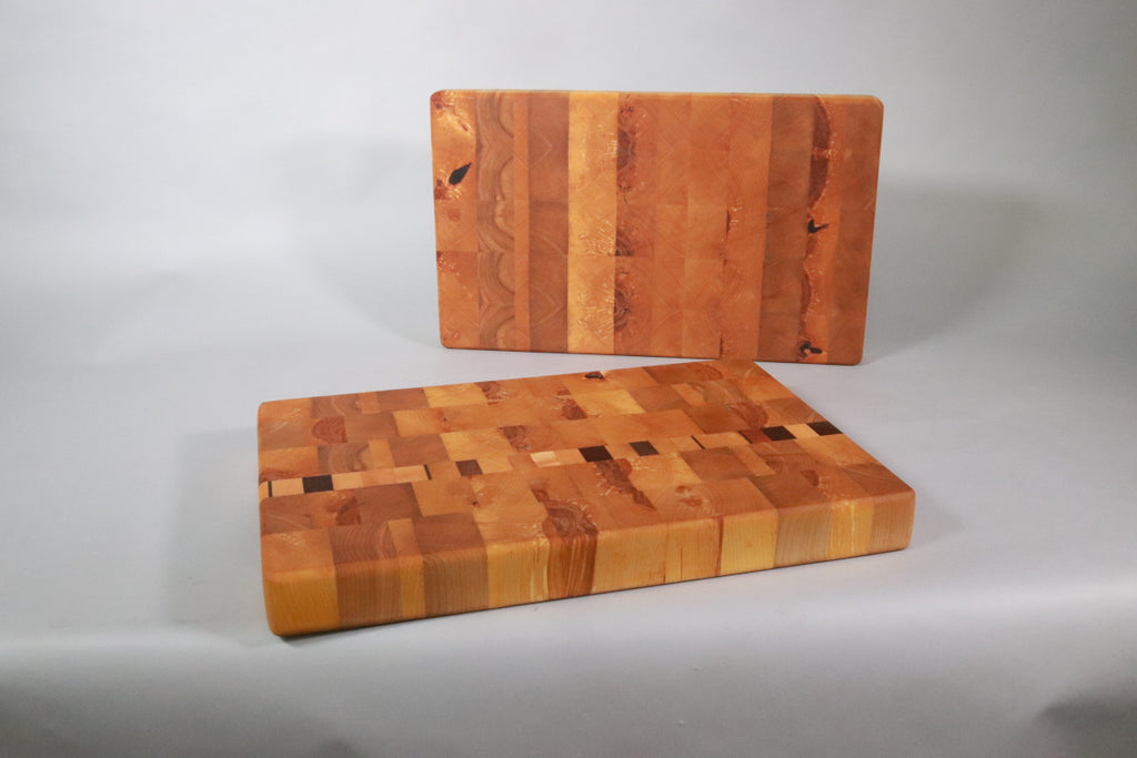 two end-grain cutting boards on a gray background. Ideal for people wanting to avoid microplastics in their food.
